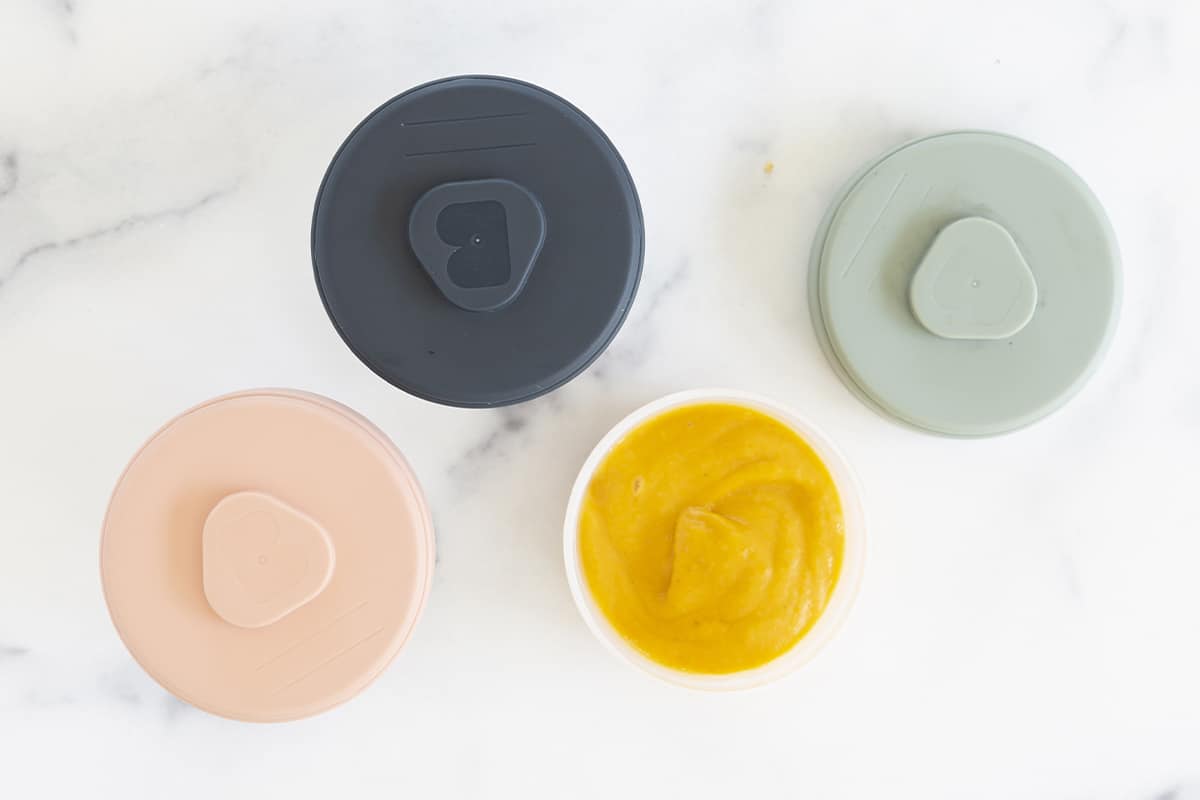 tops of baby food storage containers on countertop.