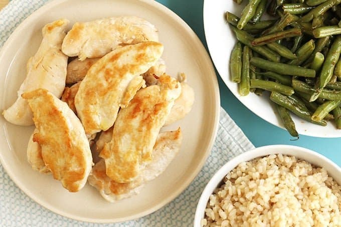 chicken tenders, brown rice, and green beans in bowls