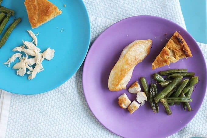 healthy pan-seared chicken on kids plates with green beans and bread