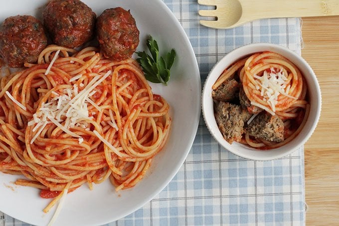 healthy meatballs with spaghetti in white bowls