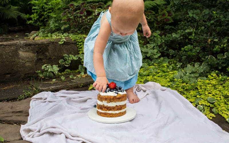 toddler girl with smash cake