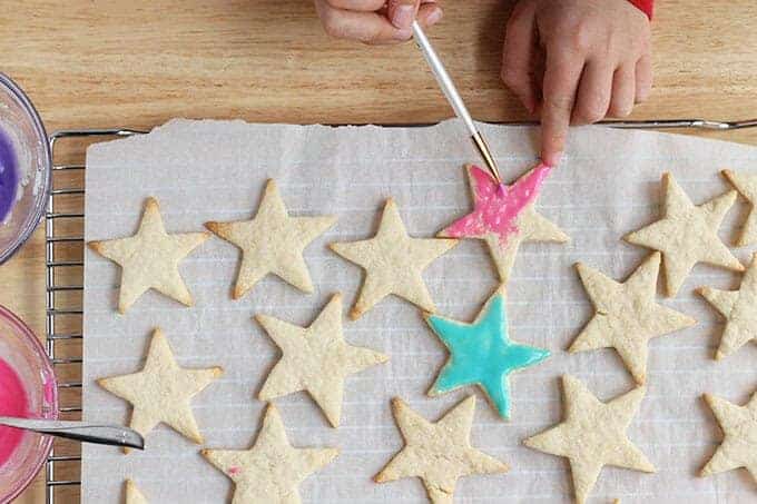 icing healthy sugar cookies with paintbrush