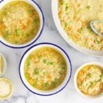 Pastina soup in numerous bowls with spoons and sides.