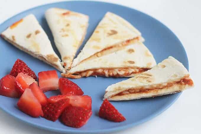 pizza quesadillas on blue plate with berries