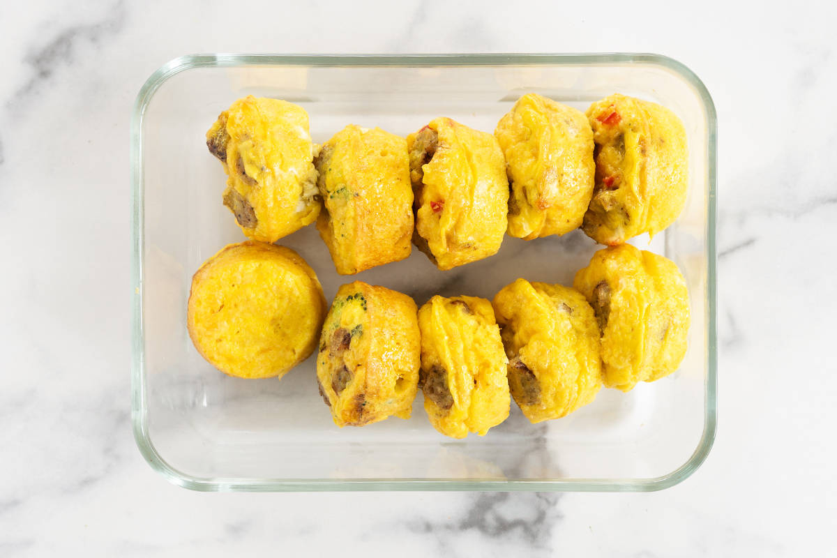 Sausage egg muffins in storage container.