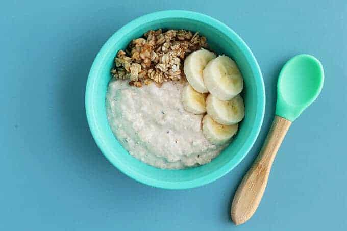 overnight oats for kids in a blue bowl with a bamboo spoon